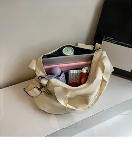 Detail view of the large capacity canvas tote bag showing inner storage for laptops and items