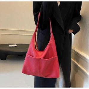 Detail of rose pink large tote bag with textured leather and dual front pockets