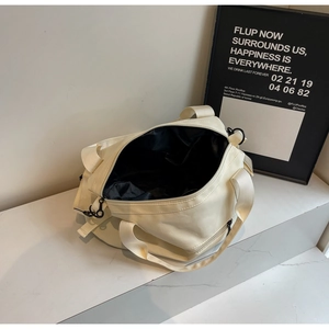 Internal view of beige canvas tote bag with black lining and secure zipper closure