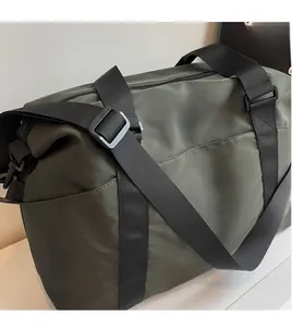 Close-up of army green travel bag featuring a smooth long adjustable shoulder strap