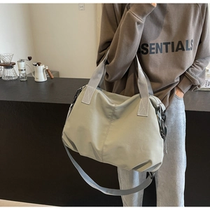 Close-up of minimalist large-capacity travel tote bag with durable nylon straps and zipper