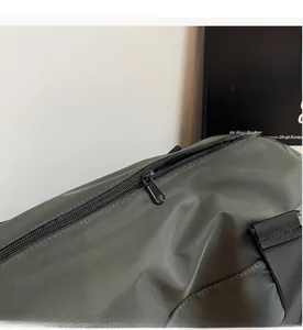 Close-up of smooth metal zipper and tear-resistant fabric on the green travel bag