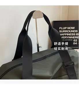 Detail of army green travel bag showing reinforced black woven handles and durable nylon fabric
