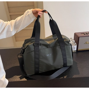 Detail of army green nylon travel bag featuring reinforced handles and side pocket storage