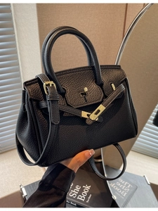 Classic black lychee grain leather handbag with gold twist lock and crossbody strap