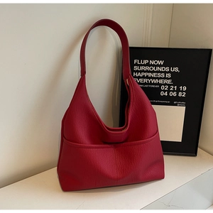 Detail shot of red litchi texture leather hobo bag with practical front pocket design