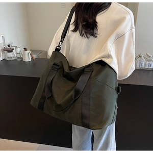 Large olive green travel duffel bag for sports and weekend trips shown on model back