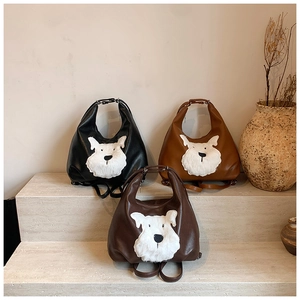 Detail of multi-functional leather bags with cute plush dog patchwork in various colors