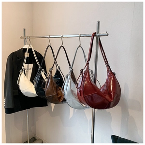 Selection of five shiny hobo bags in white black coffee silver and burgundy on hangers