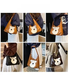 Detail of hobo tote bag featuring a cute white schnauzer plush patch and smooth finish