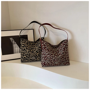 Detail view of jacquard leopard print bucket bags in yellow and red pattern variations