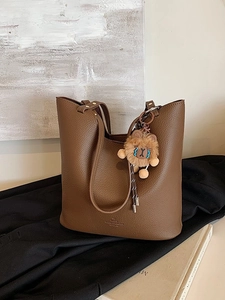 Vintage large brown leather tote bag with lion plush charm and textured finish
