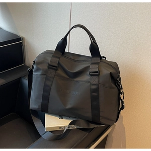Close-up of black travel bag showing durable nylon texture and reinforced woven handles