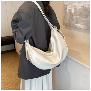 Detailed back view of a minimalist cream-white large crescent bag with adjustable wide strap