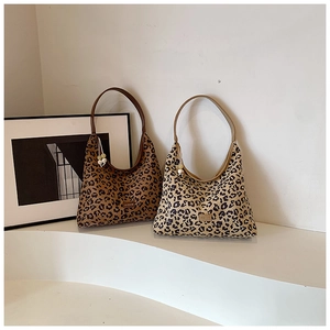Detail of leopard print hobo bags with single brown shoulder straps and beaded charms