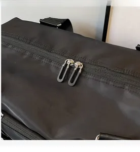 Detail of smooth metal dual zippers on high-density waterproof nylon travel bag