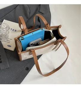Interior view showing the large capacity and storage space of the beige tote bag