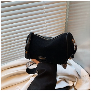 Detail of black suede Boston bag with geometric jacquard strap and Fashion patch accent