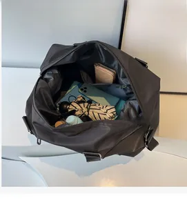 Spacious interior of black nylon travel bag showing zippered pocket and storage capacity