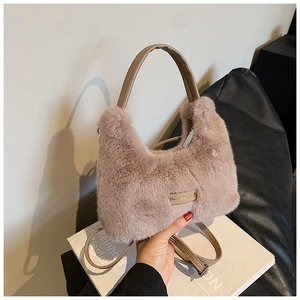 Detail of plush faux fur handbag in dusty rose with love every day metal tag