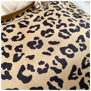 Macro shot of faux suede leopard print tote bag with fine stitching and bead detail