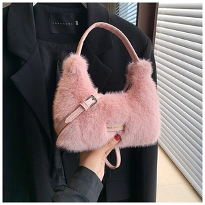 Detail of pink faux fur handbag showing soft texture and adjustable leather strap