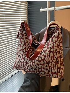 Large leopard print jacquard tote bag with reddish brown leather strap and gold buckle