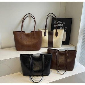Detailed display of four vintage large tote bags in brown, beige, black, and coffee leather