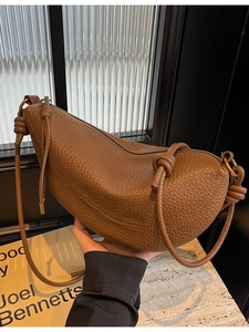 Brown lychee-texture leather crescent shoulder bag with knot detail and gold metal ring