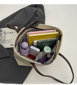Spacious interior of a cream tote bag showing capacity for a tablet and daily essentials