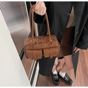 Retro brown leather handbag with double pockets shown on model for size perspective