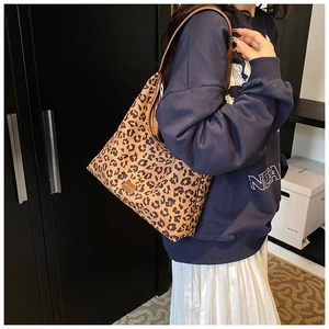 Detail of leopard print hobo bag showing the wild texture and leather brand patch