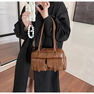 Brown retro shoulder bag worn by model showing its large capacity and stylish shape