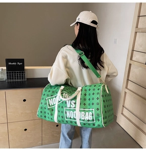 Borsa da viaggio verde a spalla con motivi monogramma neri e tracolla bianca regolabile