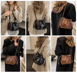 Detailed views of vintage brown drawstring bucket bag with decorative woven rope charms