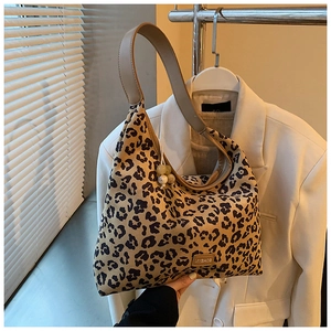 Detail of hobo bag featuring leopard print, wide strap, and MYBAGS brand label