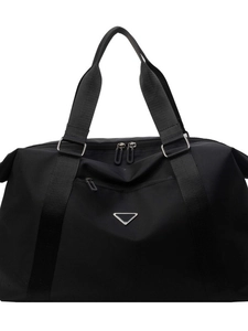 Large black nylon travel duffle bag with double handles and triangle metal logo