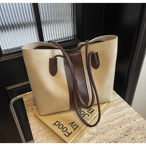 Detail of two-tone tote bag with vintage wrinkled texture on a marble background