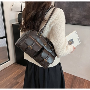 Close-up of retro brown shoulder bag with multi-pockets and gold hardware detail