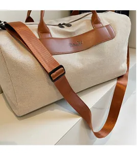 Detail of fabric crossbody bag with smooth shoulder strap and leather trim finish