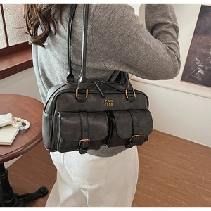 Close-up of vintage black leather bowling bag featuring front pockets and PAN TOR logo