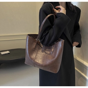 Deep brown tote bag with vintage faux leather texture and decorative stitching detail