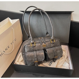 Detail view of vintage grey leather handbag with PAN TOR logo and cargo pockets