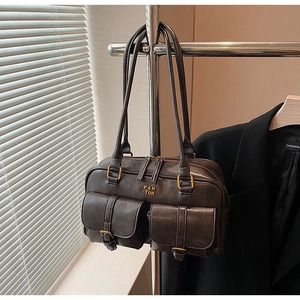 Detail of vintage faux leather tote bag with double front pockets and bronze hardware