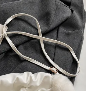 Detailed view of the smooth adjustable long shoulder strap with a gold metal buckle
