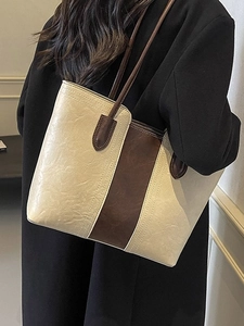 Chic two-tone cream and brown tote bag with slim shoulder straps for daily commuting