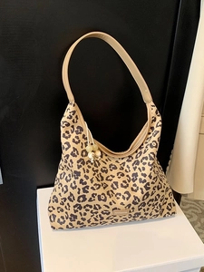 Fashionable leopard print half-moon underarm bag with decorative bead charms