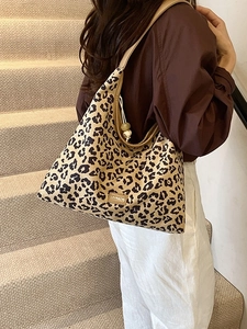 Fashionable leopard print canvas tote bag with drawstring closure and shoulder strap