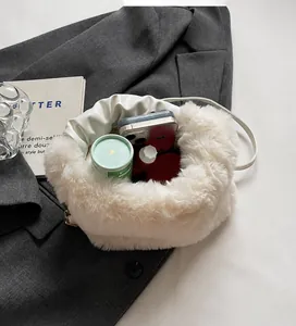 Interior view showing the spacious storage capacity of the plush cream handbag
