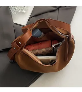 Spacious interior of brown suede tote bag showing storage for umbrella and wallet